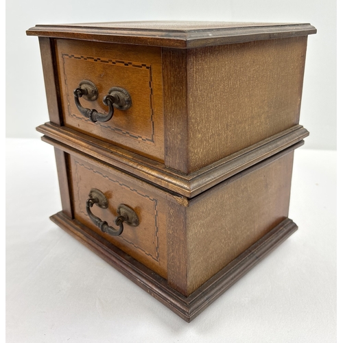 1394 - An Edwardian table top 2 draw cabinet with inlaid detail and metal drop handles. Raised on 4 wooden ... 