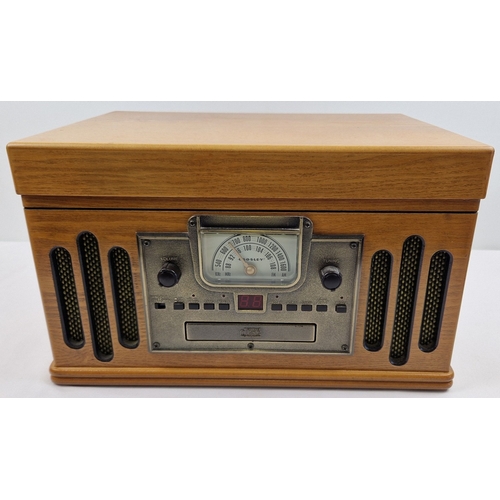 1370 - Crosley 1189986 Record/Radio/CD/Cassette player with built in speakers in a light wood finish. CD pl... 