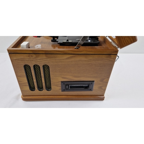 1370 - Crosley 1189986 Record/Radio/CD/Cassette player with built in speakers in a light wood finish. CD pl... 