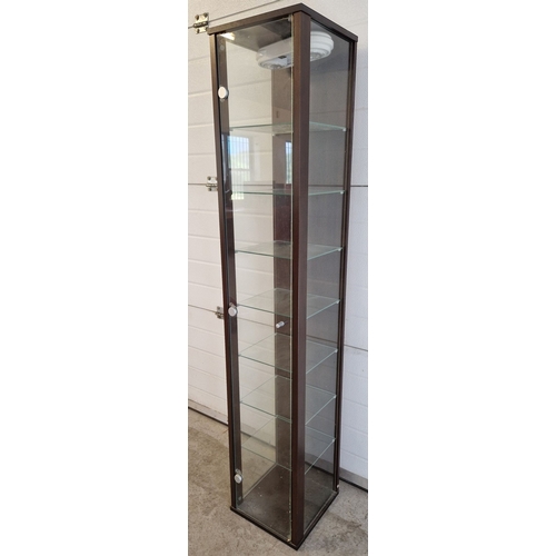 1439 - A modern tall glass display unit with 7 glass shelves, dark wood effect back and frame. Front openin... 