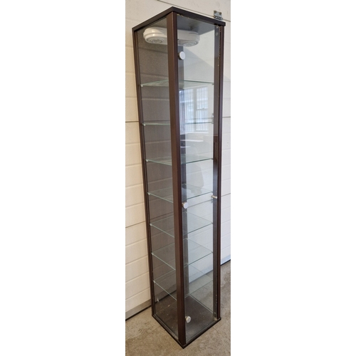 1439 - A modern tall glass display unit with 7 glass shelves, dark wood effect back and frame. Front openin... 