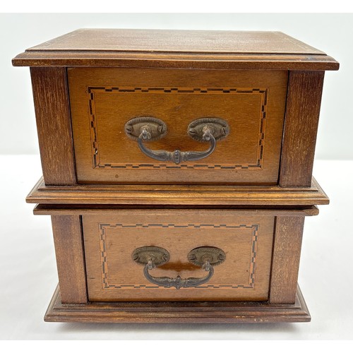 1394 - An Edwardian table top 2 draw cabinet with inlaid detail and metal drop handles. Raised on 4 wooden ... 