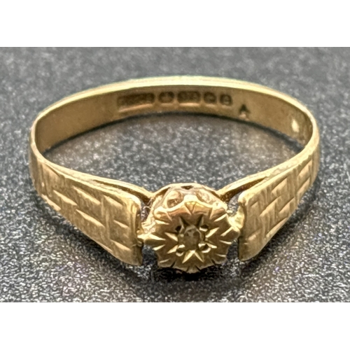 1128 - A vintage 1970's 9ct gold illusion set diamond solitaire ring with textured engraved shoulders. Full... 