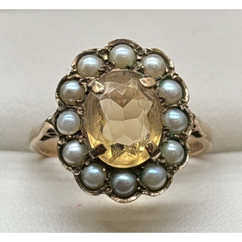 1133 - A vintage 9ct gold citrine and seed pearl dress ring with pierced shoulders and plain shank. Central... 