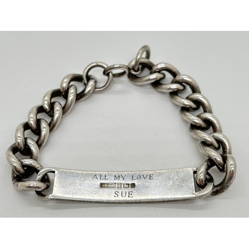 1166 - A vintage silver identity bracelet with heavy curb chain and spring ring clasp. Engraved 'C. H. D' t... 