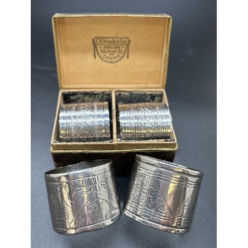 1209 - 4 vintage Egyptian silver serviette rings. A boxed matching pair with plaited design, a single ring ... 