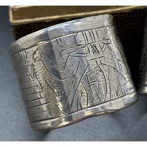 1209 - 4 vintage Egyptian silver serviette rings. A boxed matching pair with plaited design, a single ring ... 