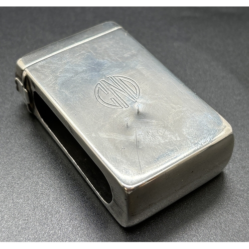 1215 - An Art Deco silver matchbox case with hinged lid, open side panels and engraved circular monogram CN... 