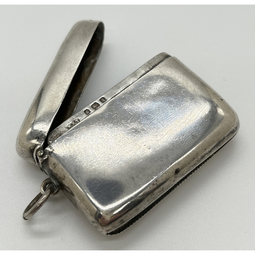 1220 - An Edwardian silver wide vesta case with hinged lid, hanging bale and striking panel to underside. H... 