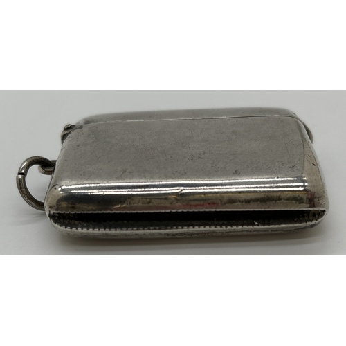 1220 - An Edwardian silver wide vesta case with hinged lid, hanging bale and striking panel to underside. H... 