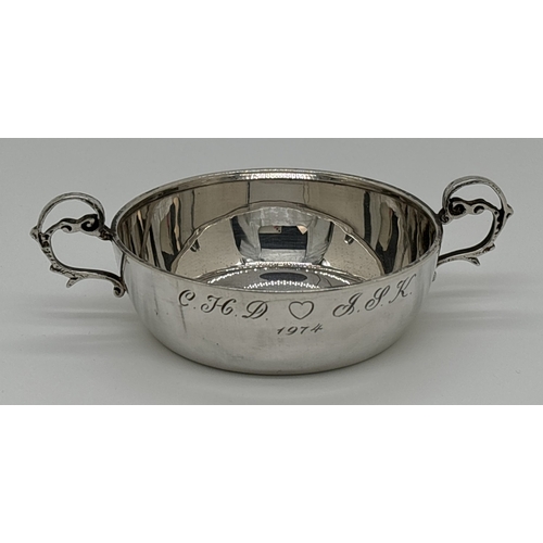 1221 - A vintage 1970's silver 2 handled flat bottomed cup or quaich with decorative looped handles. Engrav... 