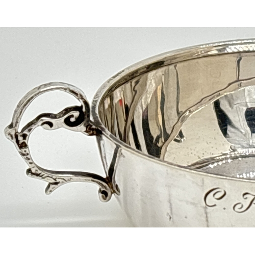 1221 - A vintage 1970's silver 2 handled flat bottomed cup or quaich with decorative looped handles. Engrav... 