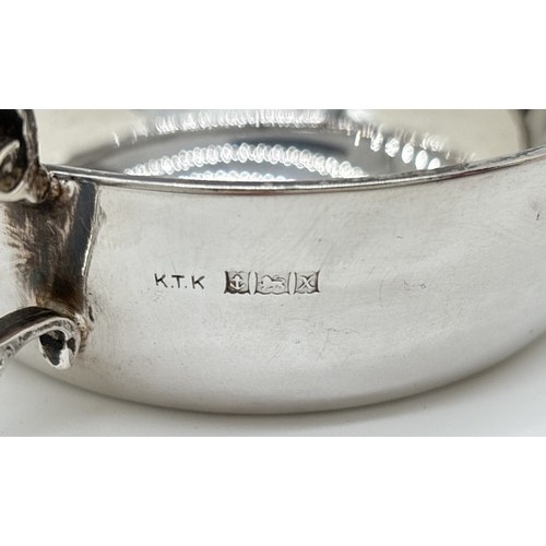 1221 - A vintage 1970's silver 2 handled flat bottomed cup or quaich with decorative looped handles. Engrav... 