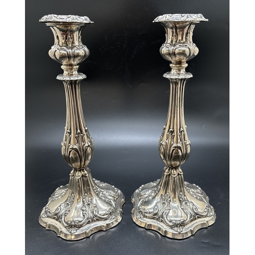 1229 - A pair of Matthew Bolton Georgian silver plated candlesticks with scroll, foliate and shell decorati... 