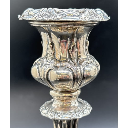 1229 - A pair of Matthew Bolton Georgian silver plated candlesticks with scroll, foliate and shell decorati... 