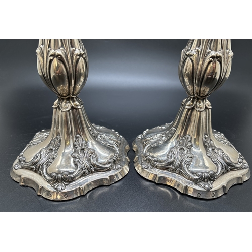 1229 - A pair of Matthew Bolton Georgian silver plated candlesticks with scroll, foliate and shell decorati... 