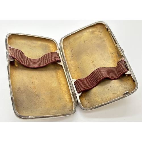 1231 - A small Edwardian silver curve backed cigarette case with gilt interior and original elastics. Hallm... 