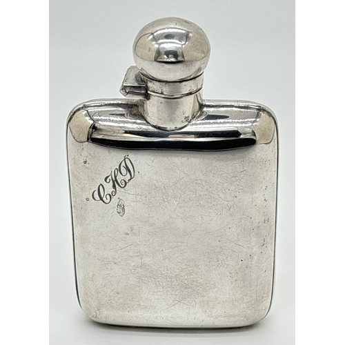 1232 - A vintage silver plated curve backed hip flask with engraved initials C.H.D. Hinged lid with cork li... 