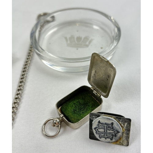 1241 - 3 small vintage collectables. A silver plated cased monogram ink stamp fob, a glass dish with engrav... 