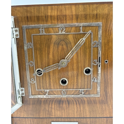 1268 - An Art Deco wooden cased westminster chime mantle clock with stepped design and inlaid panels. Pierc... 