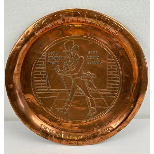 1311 - A vintage copper pub advertising tray for Johnnie Walker scotch whisky. Approx. 33.5cm diameter.