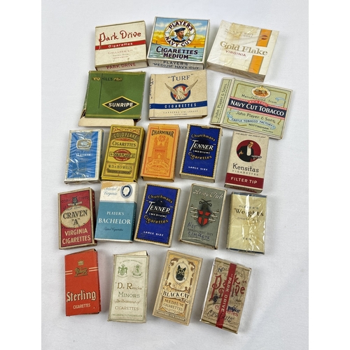 1335 - A collection of 20 assorted vintage cigarette packets (empty) by varying brands. To include Craven A... 