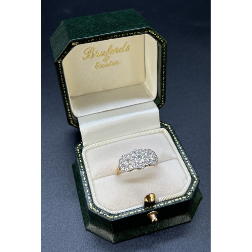 1122 - An 18ct gold & diamond triple cluster ring set with 27 brilliant cut diamonds. Mounted in platinum m... 