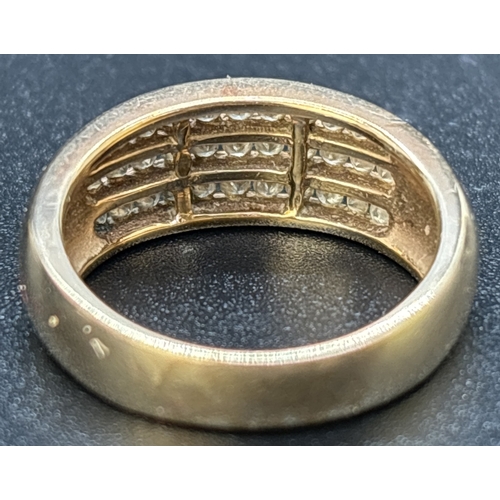 1125 - A 9ct gold band ring set with 3 rows of channel set round cut diamonds totaling 0.5ct. Gold and diam... 