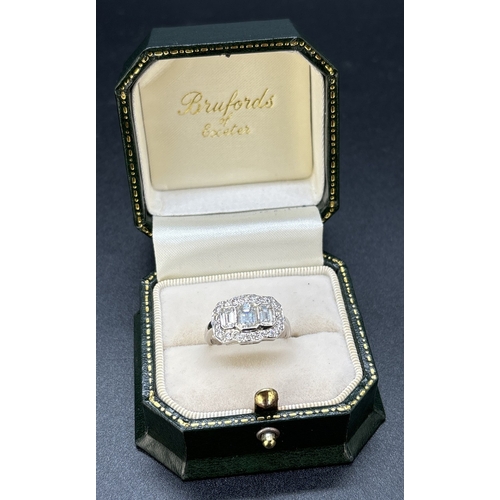 1042 - An Art Deco design 18ct white gold and diamond ring. Comprising 3 rub over set emerald cut diamonds ... 