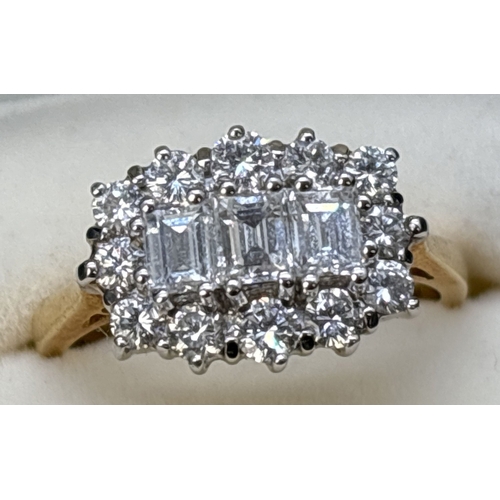 1069 - An 18ct yellow gold diamond cluster ring comprising 3 emerald cut claw set central diamonds surround... 