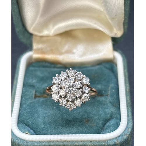 1088 - A 9ct gold graduating tiered, diamond cluster ring with split shoulders and plain shank. 19 brillian... 