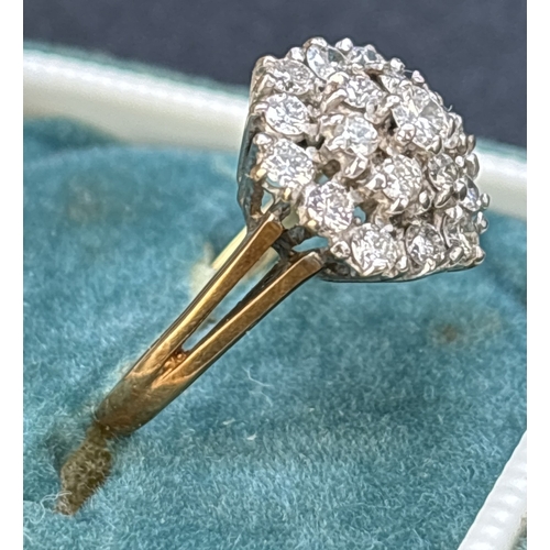 1088 - A 9ct gold graduating tiered, diamond cluster ring with split shoulders and plain shank. 19 brillian... 