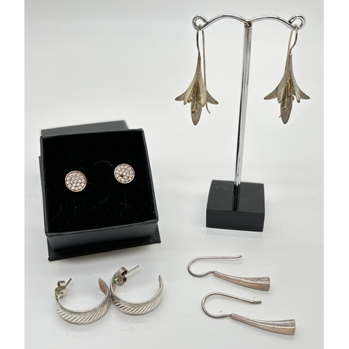 1056 - 4 pairs of silver and white metal earrings. A pair of Fuchsia flower drops, a pair of modern design ... 