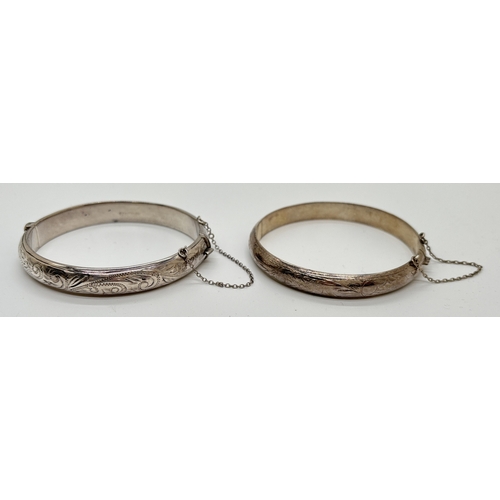 1052 - 2 vintage silver bangles, both with push clasp and safety chains. An 8mm wide bangle with full flora... 