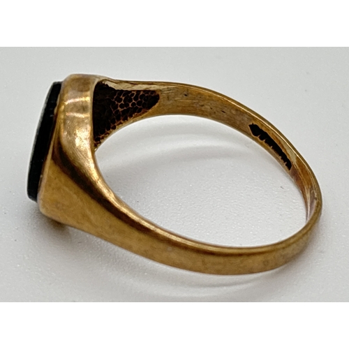 1073 - A vintage 9ct gold signet ring set with an oval of blue sandstone. Hallmarked to inside of band. Siz... 