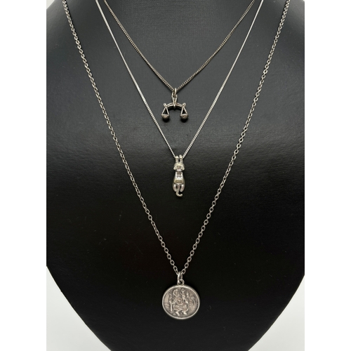 1108 - 3 silver and white metal pendant necklaces. A circular St. Christopher pendant on a 20