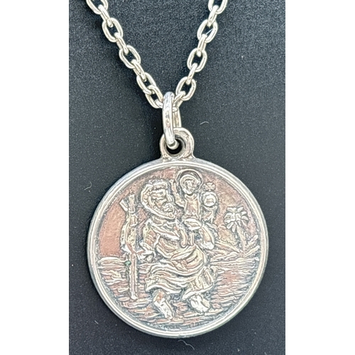 1108 - 3 silver and white metal pendant necklaces. A circular St. Christopher pendant on a 20