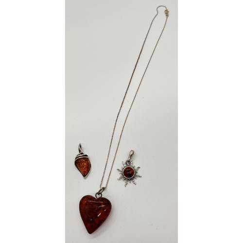 1112 - 3 amber pendants. A heart shaped cognac amber pendant on an 18