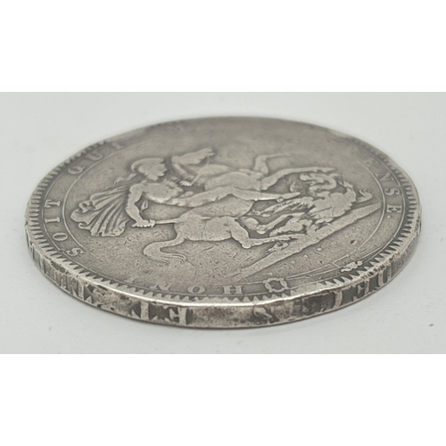 3 - A 1818 George III silver crown showing George Slaying the Dragon on reverse. Small areas of general ... 