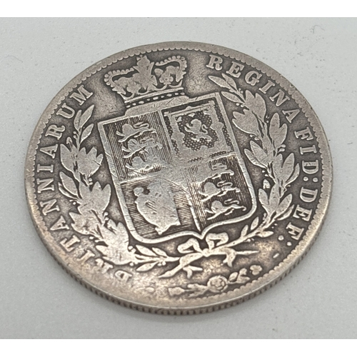 8 - A silver 1875 Victoria young head silver half crown. Crowned Shield of Arms within laurel wreath to ... 