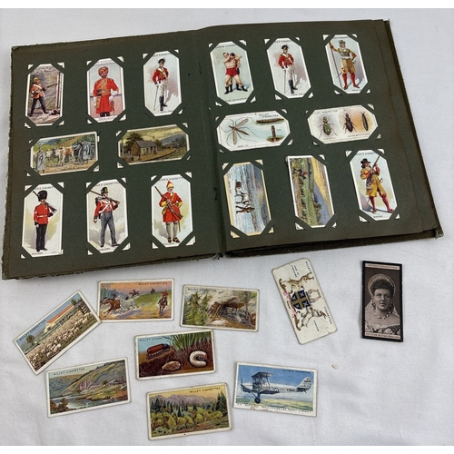 112 - A early 20th century cigarette card album containing a quantity of assorted cards to include Smith's... 