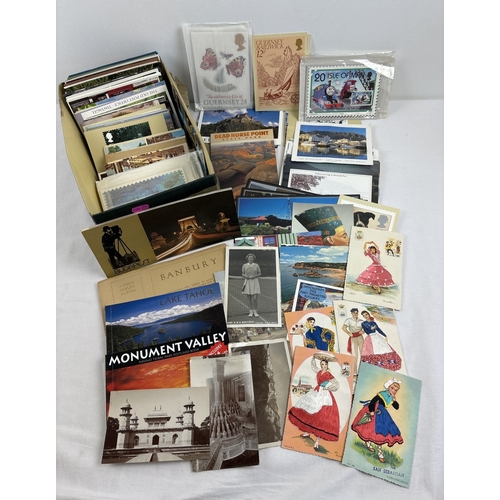 251 - A box of 200+ vintage and modern postcards. To include RP's, postcard books, foreign destination, Ro... 