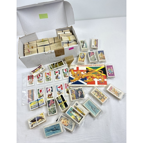 124 - A box of vintage Brook Bond Tea collectors cards, many full sets, and cigarette cards. Includes a fu... 