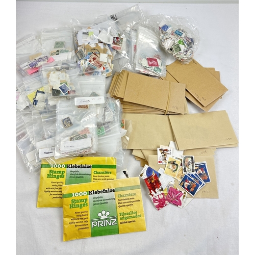 65 - A box of mixed used British and foreign vintage stamps together with 2 packed of stamp hinges. Stamp... 