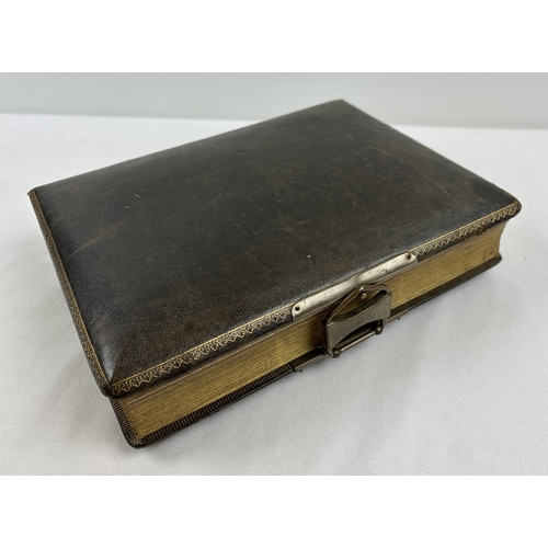 182 - A Victorian leather bound photograph album with metal clasp, containing assorted portrait cabinet ca... 