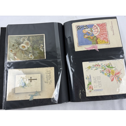 183 - A large modern album containing 196 assorted Edwardian & vintage greetings cards, in varying designs... 