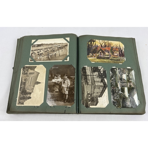 259 - An early 20th century postcard album containing 330 assorted greetings cards and British postcards, ... 