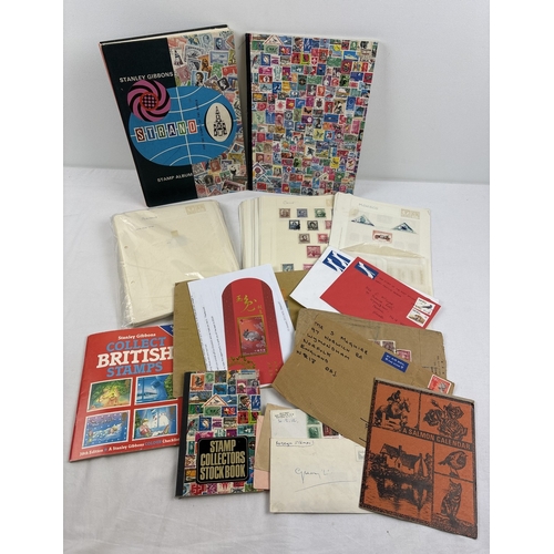 75 - A collection of assorted vintage stamp stock books, loose stamp album pages, loose stamps & stamped ... 