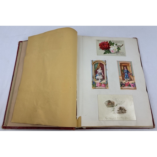 196 - A Victorian leather bound scrap album containing assorted greetings cards and scraps, dated 1881 ins... 