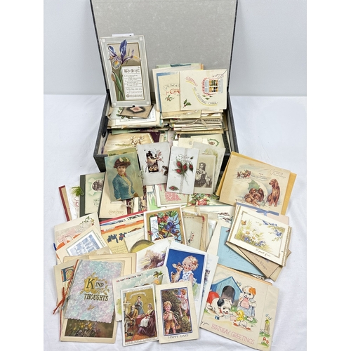 235 - A box containing 295 assorted early to mid 20th century greetings cards, in varying styles and sizes... 